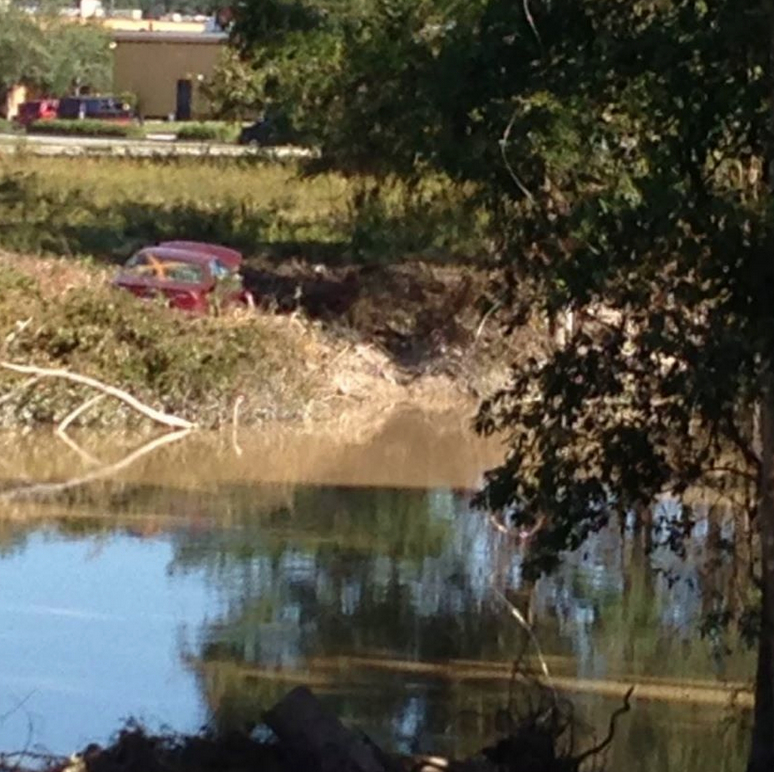 A flooded vehicle sits abandoned near Columbia, SC