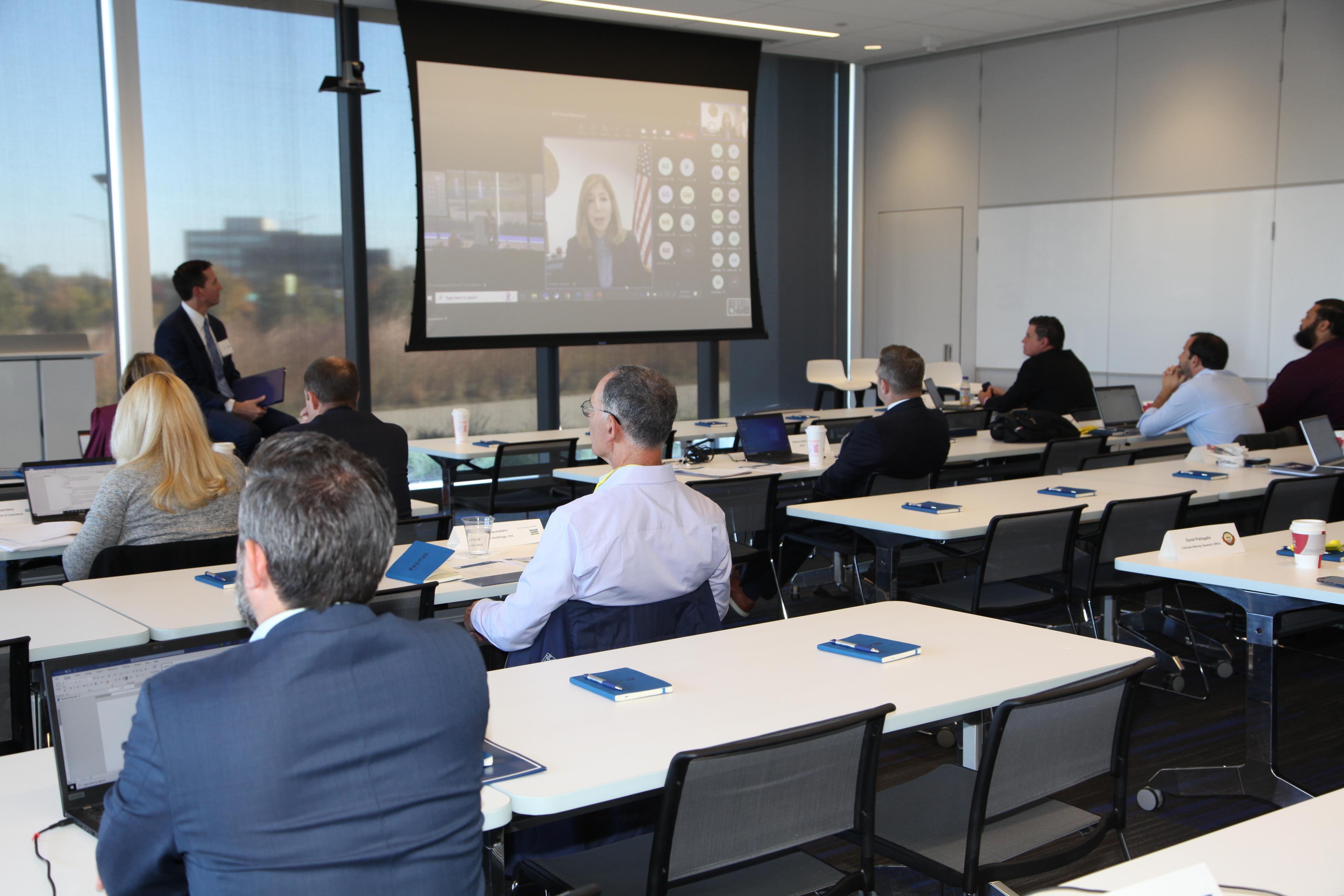 People watching a presenter on screen